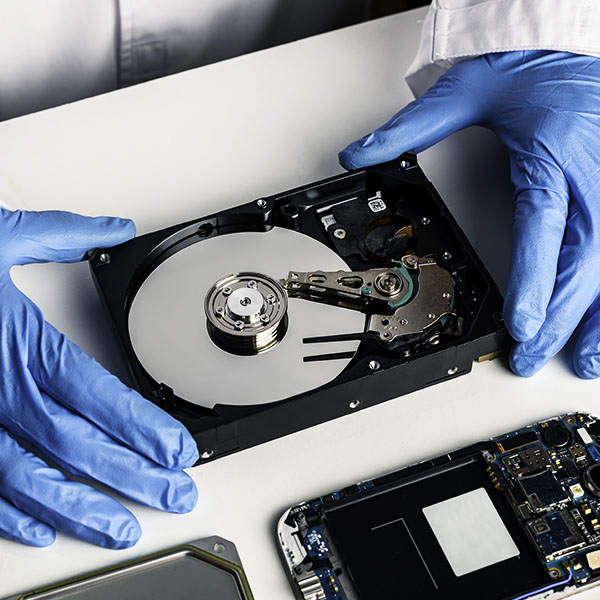 Data Recovery - A technician has opened up a computer hard drive to recover the data.
